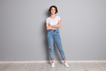 Full body photo of young confident woman crossed hands positive smile wear casual outfit isolated...