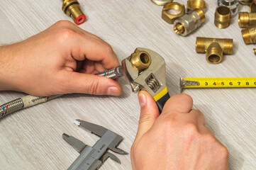 Technician installs the fitting on the hose using an adjustable wrench