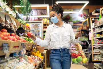 Black Woman Choosing Fresh Vegetables In Supermarket, Walking With Basket