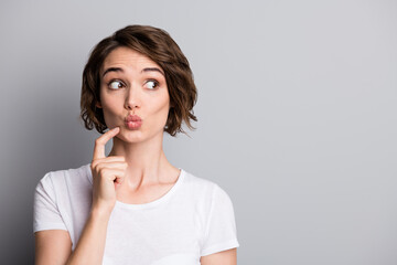 Fototapeta premium Portrait of young beautiful curious woman girl female look in copyspace pout lips isolated on grey color background