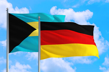 Germany and Bahamas national flag waving in the windy deep blue sky. Diplomacy and international relations concept.
