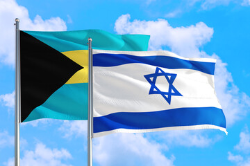 Israel and Bahamas national flag waving in the windy deep blue sky. Diplomacy and international relations concept.