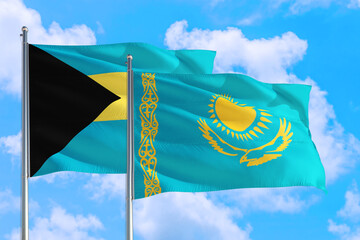 Kazakhstan and Bahamas national flag waving in the windy deep blue sky. Diplomacy and international relations concept.
