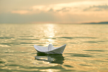 handmade paper boat on lake water