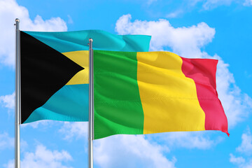 Mali and Bahamas national flag waving in the windy deep blue sky. Diplomacy and international relations concept.