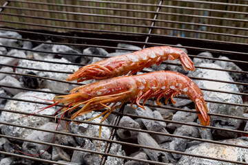 Large shrimps roast on charcoal