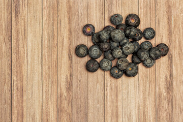 Blueberry in a bowl for healthy eating on a wooden table with copy space