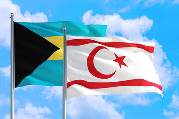 Northern Cyprus and Bahamas national flag waving in the windy deep blue sky. Diplomacy and international relations concept.