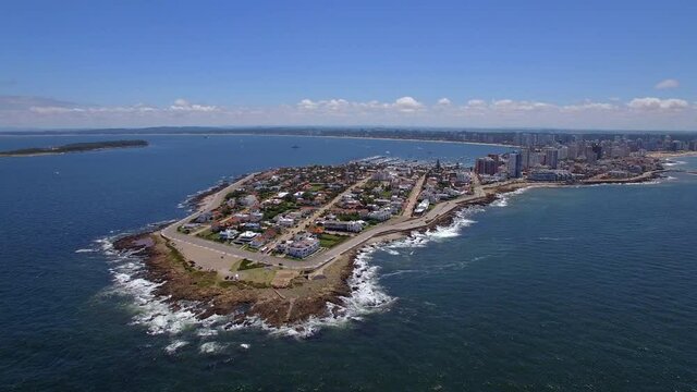 Aerial jib shot showing Punta del Este cityscape and coastline during summer, Maldonado Department, Uruguay.