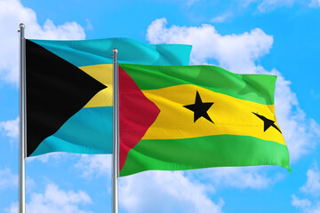 Sao Tome And Principe and Bahamas national flag waving in the windy deep blue sky. Diplomacy and international relations concept.