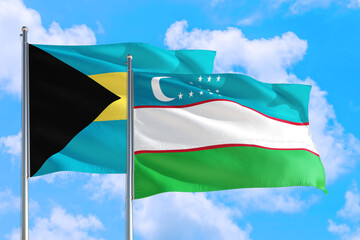 Uzbekistan and Bahamas national flag waving in the windy deep blue sky. Diplomacy and international relations concept.
