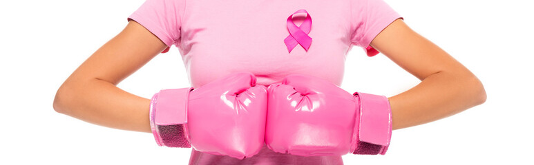 Cropped view of woman in boxing gloves and pink ribbon of breast cancer awareness isolated on white, banner