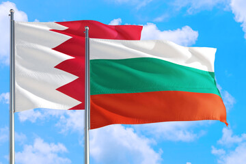 Bulgaria and Bahrain national flag waving in the windy deep blue sky. Diplomacy and international relations concept.