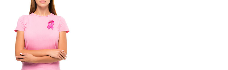 Cropped view of woman with crossed arms and pink ribbon of breast cancer awareness isolated on white, banner