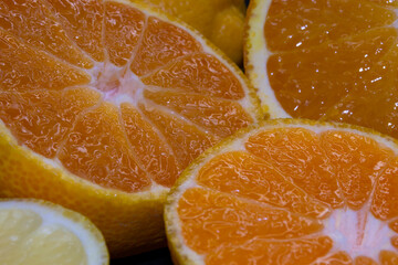 Fototapeta na wymiar sliced ​​fresh orange and tangerine close up