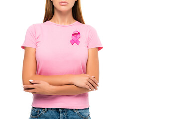 Cropped view of woman with ribbon of breast cancer awareness and crossed arms isolated on white