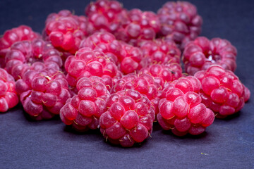 fresh raspberries on black background