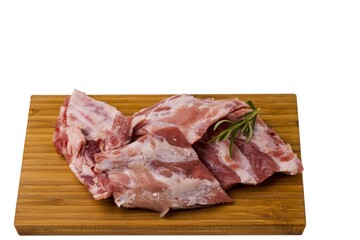 Close up view of raw pork ribs on wooden cutting broad. Cooking and food concept.