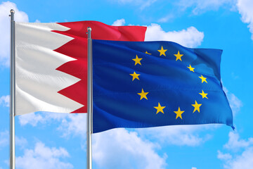 European Union and Bahrain national flag waving in the windy deep blue sky. Diplomacy and international relations concept.