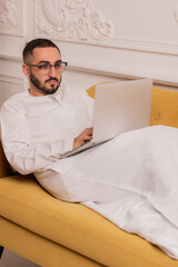 Arab businessman working on laptop computer at home