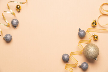 Two sparkling golden ribbons on light beige background with decorative toys.  Christmas and New Year holidays greeting card, copy space, top view