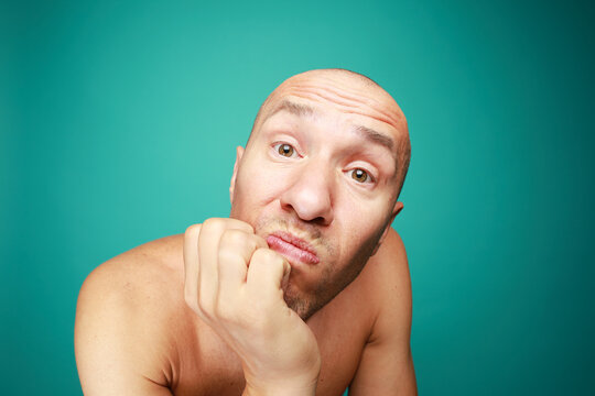 Portrait of funny naked bald man isolated on green background 