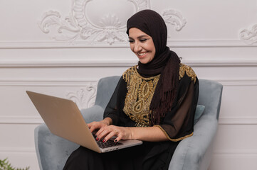 arab business woman working on laptop from home