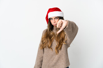 Caucasian girl with christmas hat isolated on white background showing thumb down with negative expression