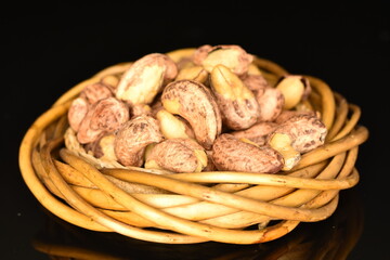 Fragrant roasted cashews, close-up, on a black background.