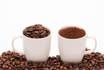 two white porcelain cup with coffee bean capsule and ground powder, coffee beans, with white background