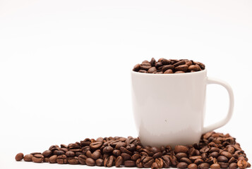 white ceramic cup, with coffee beans and white background