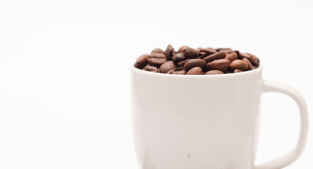 white ceramic cup, with coffee beans and white background