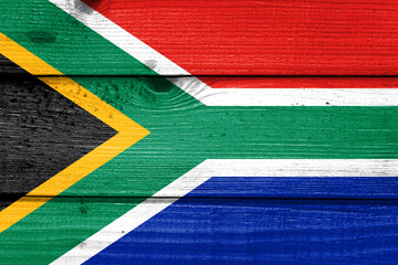 South Africa flag painted on old wood plank background. Brushed natural light knotted wooden board texture. Wooden texture background flag of South Africa