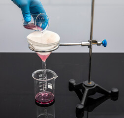 Filter paper in laboratory. Scientists are chemical filtration by filtering through filter paper in...