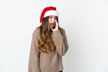 Caucasian girl with christmas hat isolated on white background shouting with mouth wide open