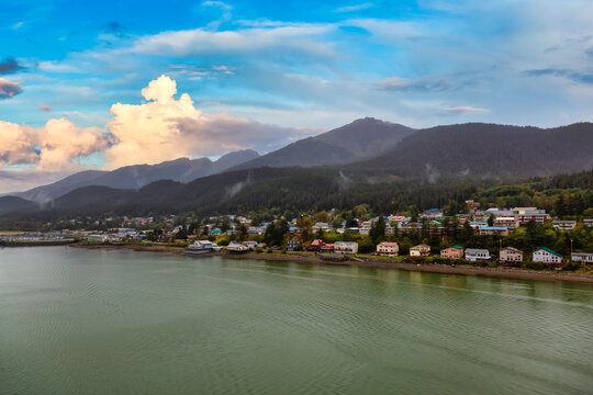 Beautiful view of a small town, Juneau, with mountains in the background. Colorful Sunset Sky. Taken in Alaska, United States.