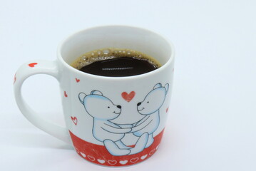 Coffee in mug with teddy bear and heart on it, valentine