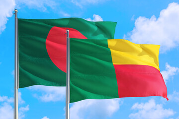 Benin and Bangladesh national flag waving in the windy deep blue sky. Diplomacy and international relations concept.