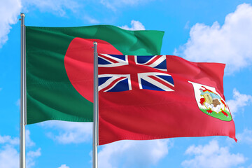 Bermuda and Bangladesh national flag waving in the windy deep blue sky. Diplomacy and international relations concept.
