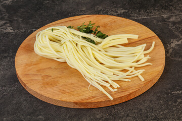 Chechil spaghetti cheese over board