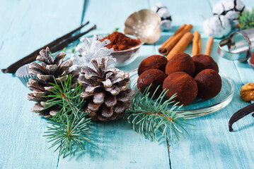 Christmas chocolate truffles and spices on shabby chic blue wood table