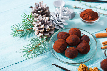 Christmas chocolate truffles and spices on shabby chic blue wood table