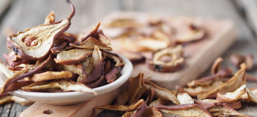 Dried pear on a wooden ancient background. Home harvesting dried fruits.