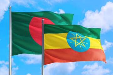 Ethiopia and Bangladesh national flag waving in the windy deep blue sky. Diplomacy and international relations concept.
