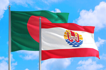 French Polynesia and Bangladesh national flag waving in the windy deep blue sky. Diplomacy and international relations concept.
