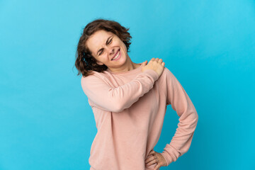 Young English woman isolated on blue background suffering from pain in shoulder for having made an effort