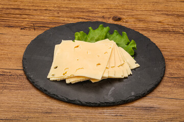 Sliced yellow cheese over board