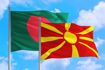 Macedonia and Bangladesh national flag waving in the windy deep blue sky. Diplomacy and international relations concept.