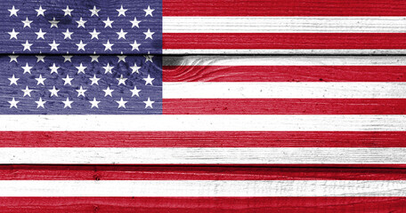 The United States flag painted on old wood plank background. Brushed natural light knotted wooden board texture. Wooden texture background flag of The United States.