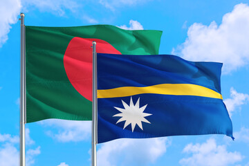 Nauru and Bangladesh national flag waving in the windy deep blue sky. Diplomacy and international relations concept.